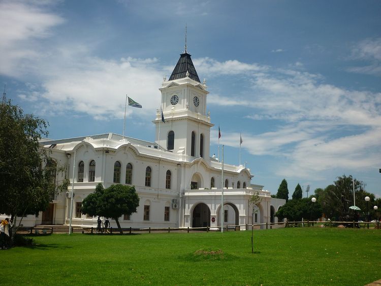 Krugersdorp Town Hall, a white building with a clock tower, behind a lawn